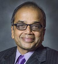 man with glasses and suit and tie